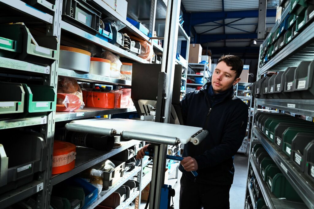 RS4432_Pronomic_Lift&Drive E_PE platform and 3-sided free rollers for cartons in racks_SE25_-6